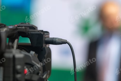 Preview: Close-Up of TV Camera Recording Press Conference