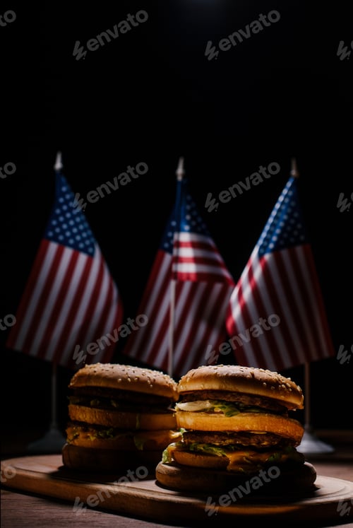 Preview: tasty burgers on wooden cutting board in front of small united states flags