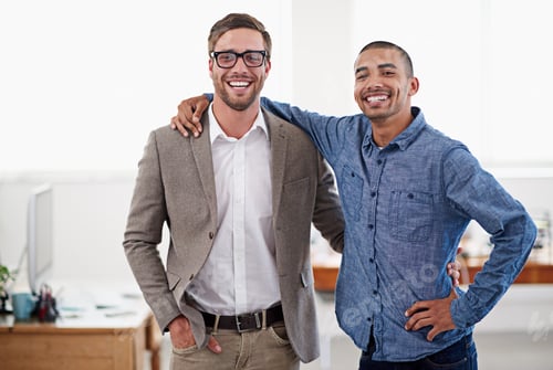 Preview: We get it done every time. Shot of two colleagues standing arm in arm in an office.