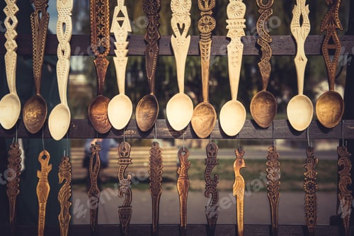 Preview: Handmade ornated wooden spoons hanging in a fair