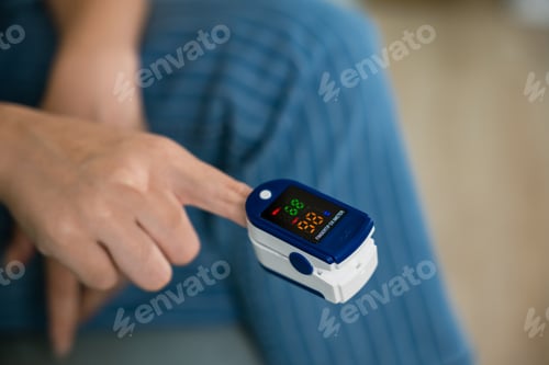 Preview: woman using medical oximeter equipment to measure pulse oxygen saturation