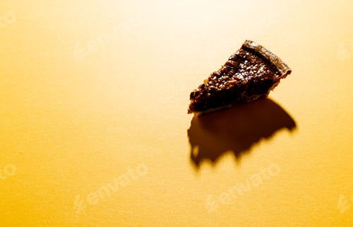 Preview: Composition of piece of pie with shadow on orange background