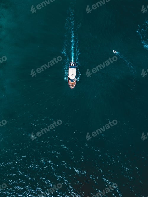 Preview: a small boat in the water on a blue sky day