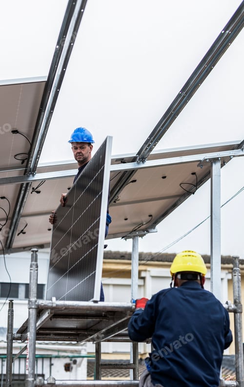Preview: Workers installing solar panel on rooftop using scaffolding