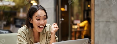 Preview: Vertical shot of happy girl talking on video call, looks at laptop, having online meeting, sitting
