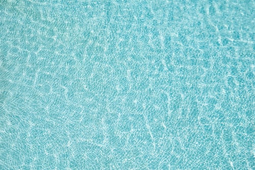 Preview: Blue water surface and sun reflection in swimming pool
