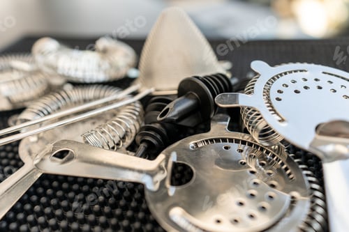 Preview: Closeup of a variety of kitchen utensils arranged on a black surface