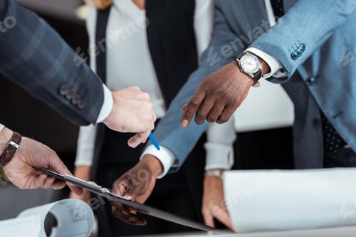 Preview: cropped view of african american man gesturing near partner holding clipboard and pen