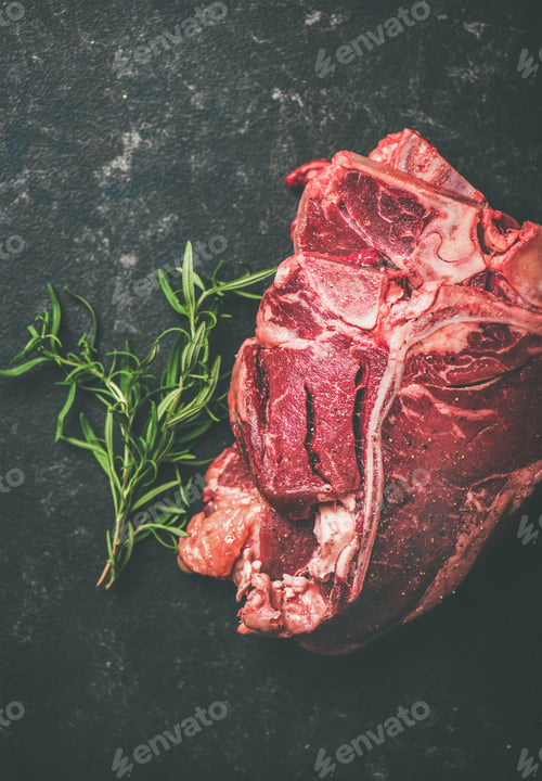 Preview: Close-up of fresh raw beef meat t-bone steaks with rosemary