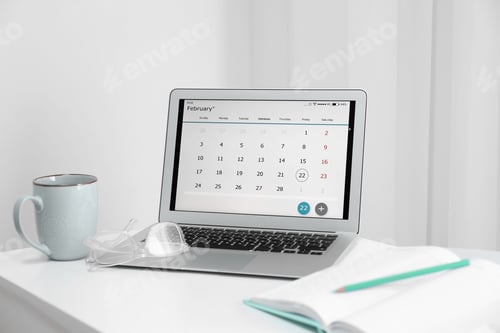 Preview: Modern laptop with calendar on screen in office