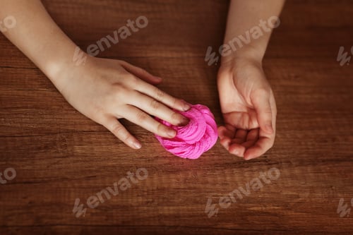 Preview: The child is holding a toy called mucus, the child is having fun and experimenting