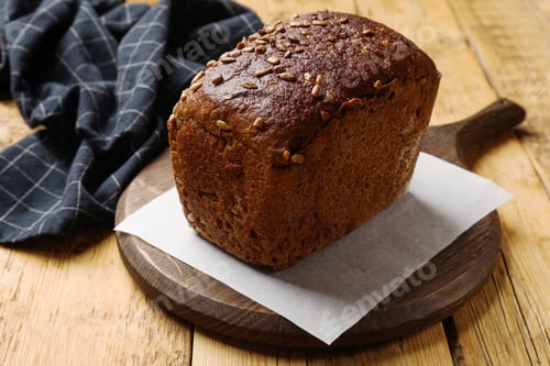 Preview: Fresh loaf of bread on wooden table, closeup