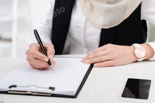 Preview: partial view of businesswoman signing papers at workplace