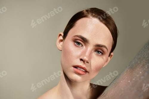 Preview: Captivating expression of beauty and elegance from a young woman against a neutral background
