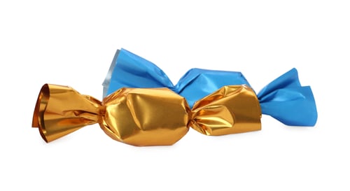 Preview: Delicious candies in colorful wrappers on white background