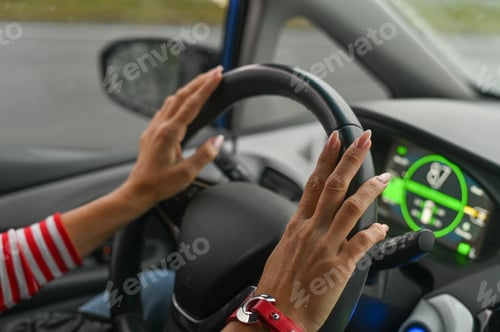 Preview: women's hands on the steering wheel. concept