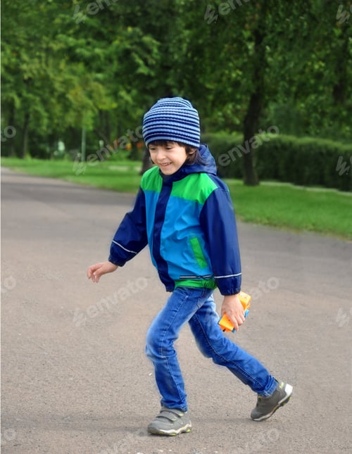 Preview: Happiness boy 4-5 years old playing and running in city's park. Happiness childhood