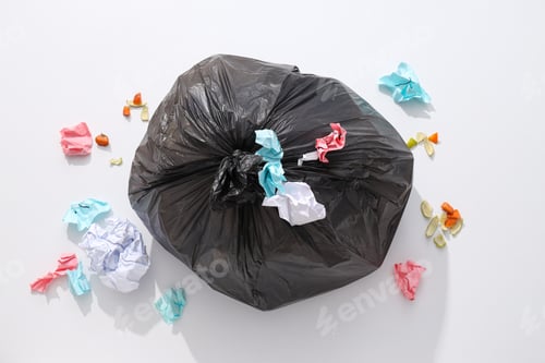Preview: Garbage bag with rubbish and papers on white background, top view