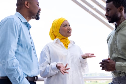 Preview: Happy diverse business people discussing and smiling outside office