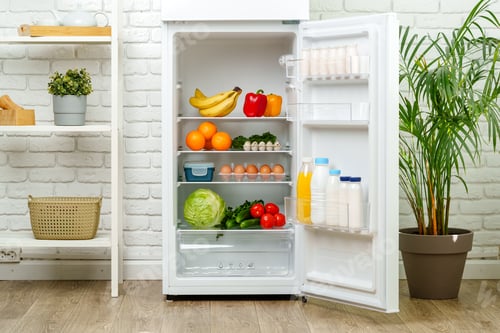 Preview: White Refrigerator Open With Fresh Produce and Dairy