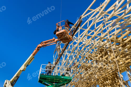Preview: Construction workers assembling wooden structure on clear day in bustling urban area