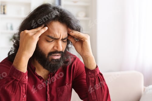 Preview: Closeup of millennial indian man have strong headache