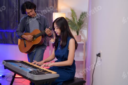 Preview: Young Asian band performing music indoors with guitar, keyboard