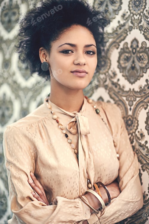 Preview: Studio portrait of a young woman in a vintage blouse posing against a wallpaper background