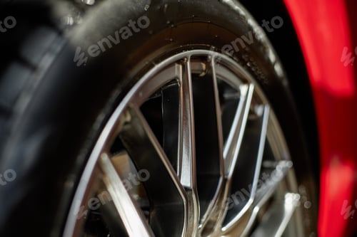 Preview: Closeup Showing Shiny Alloy Wheel of Modern Car in Sunlight Outdoors