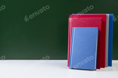 Preview: Happy teacher's day. Books on white table against chalkboard. Space for text