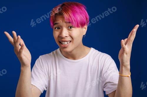 Preview: Asian boy with pink hair expressing surprise at camera