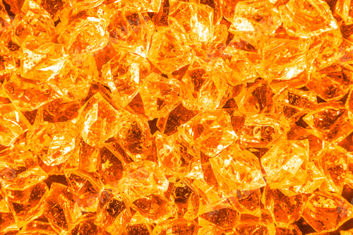 Preview: Pile of crushed ice as background, top view. Toned in orange color