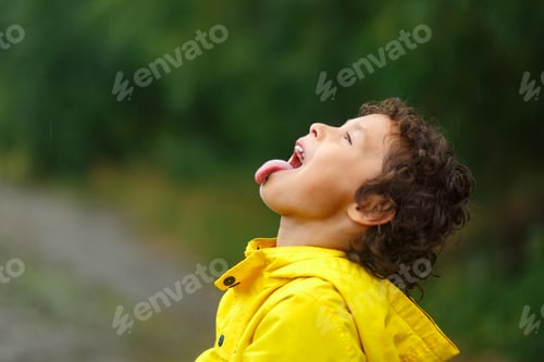 Preview: Boy catching raindrops by his tongue