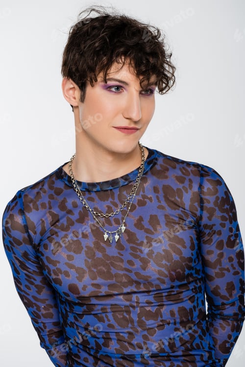 Preview: portrait of brunette nonbinary model in stylish long sleeve shirt and silver necklaces isolated on