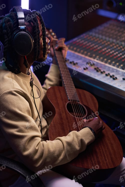 Preview: Man using guitar to write a new song