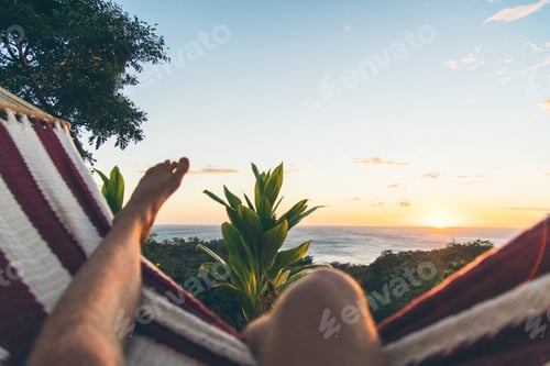 Preview: Person relaxing on the beach and enjoying the beautiful view of the sunrise in Nicaragua