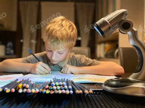 Preview: Young Boy Drawing With Colored Pencils Indoors