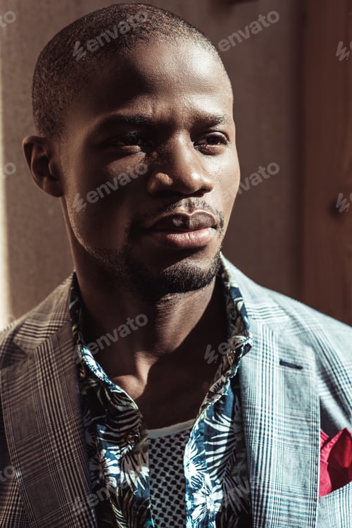 Preview: Portrait of young african american man in stylish clothes, looking aside
