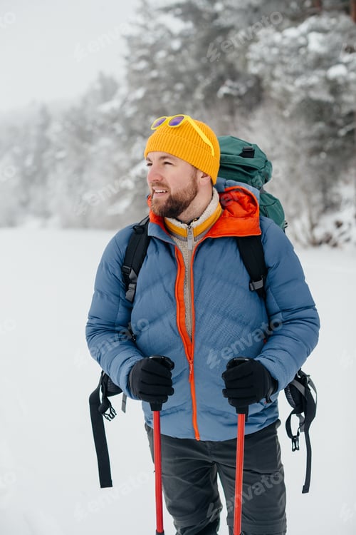 Preview: Man hiking solo through winter snowy landscape