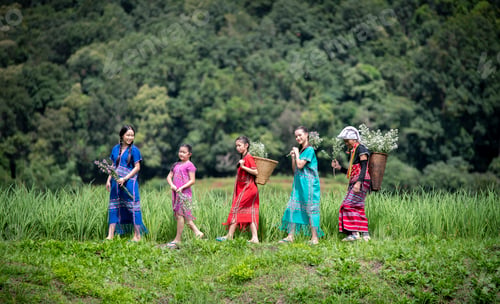 Preview: people, possibly from different generations, dressed in colorful traditional clothing, standing in a