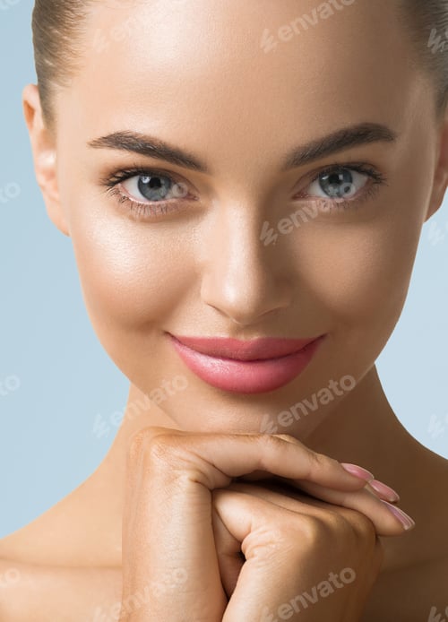 Preview: Clean skin woman face close up skin beauty tanned face beautiful smile over blue background