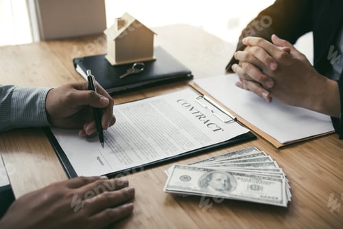 Preview: New home buyers are signing a home purchase contract at the agent's desk.