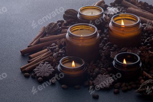 Preview: Soy scented candle in a jar. Coffee beans, anise, cinnamon spices. The candles are burning. Dark