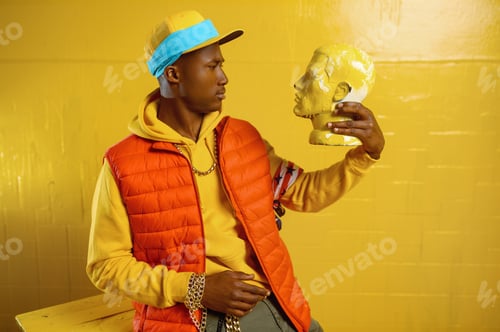 Preview: Stylish rapper poses in studio with yellow tones
