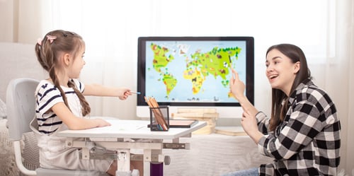 Preview: A mother with a child sits at the table and does homework. The child learns at home. Home schooling.