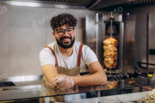 Preview: Smiling chef presenting kebab restaurant service
