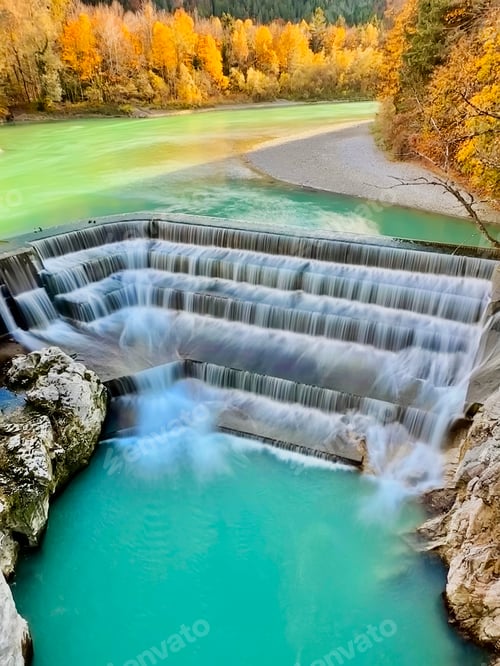 Preview: Aerial View To Blue Waterfall Water Surrounded By Autumn Colorful Yellow Orange Trees