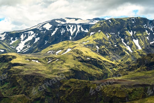 Preview: Green mountain with moss rough texture and snow covered in Icelandic highlands at Iceland
