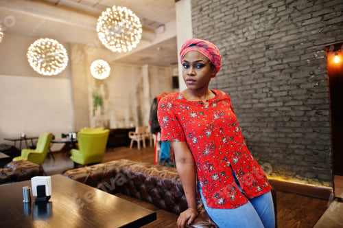 Preview: Stylish african woman in red shirt and hat