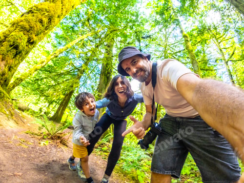 Preview: Family taking a selfie in cathedral grove forest on vancouver island